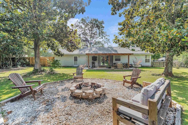 23214 Rochelle Loop, Robertsdale, AL 36567 - rear view of property featuring a fenced backyard, a patio, and an outdoor living space with a fire pit