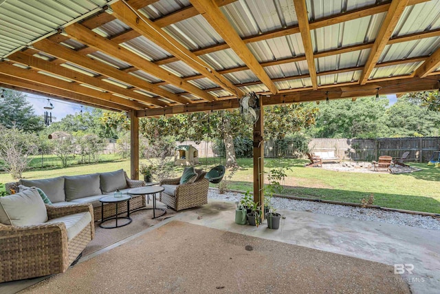 23214 Rochelle Loop, Robertsdale, AL 36567 - fenced backyard featuring a patio and an outdoor living space with a fire pit