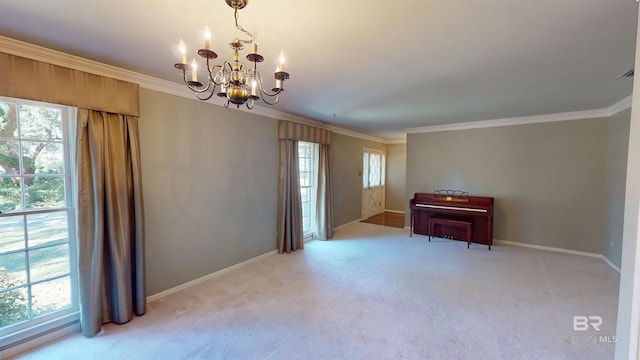 empty room with a healthy amount of sunlight, crown molding, and a notable chandelier