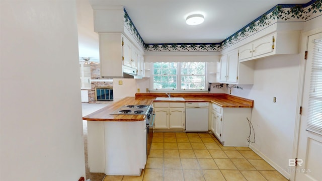 kitchen with stainless steel electric stove, white cabinets, white dishwasher, wood counters, and a sink