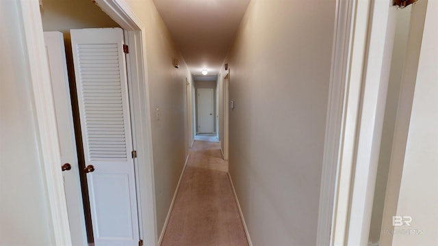 hallway featuring baseboards