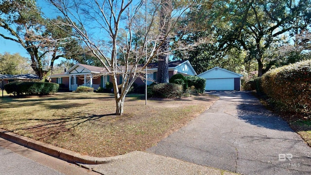 single story home featuring a front lawn, an outdoor structure, and a detached garage