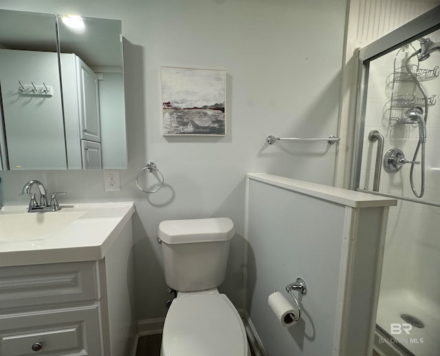 full bath with vanity, toilet, and a stall shower