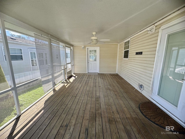 wooden deck with a ceiling fan