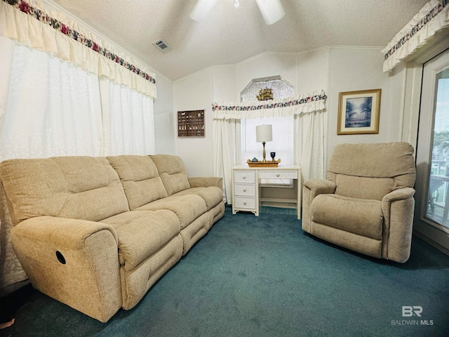 carpeted living room featuring crown molding, visible vents, lofted ceiling, a textured ceiling, and a ceiling fan