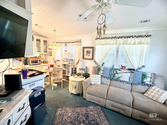 living room with a ceiling fan, a textured ceiling, visible vents, and dark colored carpet