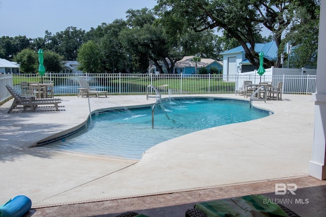 view of swimming pool featuring a patio area