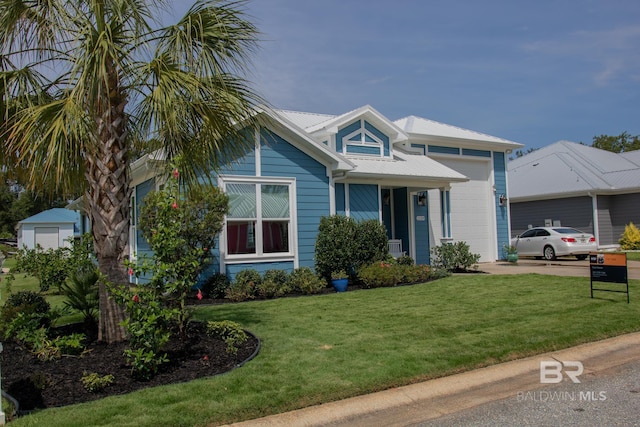 view of front of property with a garage and a front lawn