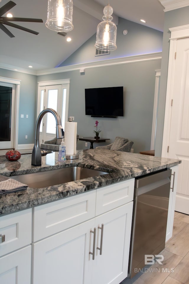 kitchen featuring ceiling fan, vaulted ceiling, light wood-type flooring, and pendant lighting