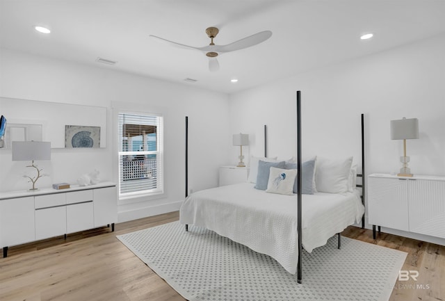 bedroom with light wood finished floors, visible vents, and recessed lighting