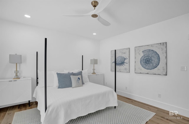 bedroom with recessed lighting, baseboards, and wood finished floors