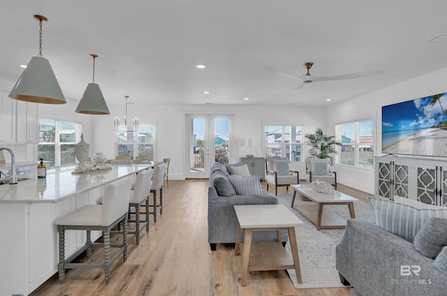 living area featuring recessed lighting, plenty of natural light, and light wood-style floors