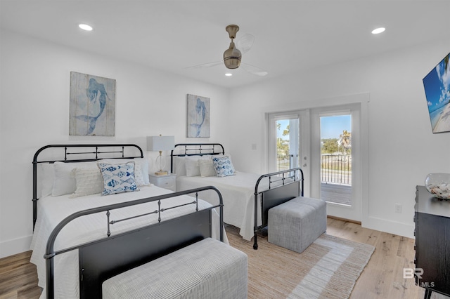 bedroom with access to outside, recessed lighting, wood finished floors, and baseboards