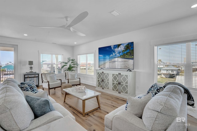 living area featuring recessed lighting, visible vents, light wood-style flooring, and ceiling fan