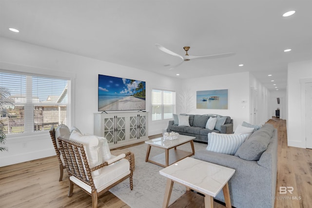 living room with recessed lighting, light wood-style floors, baseboards, and ceiling fan