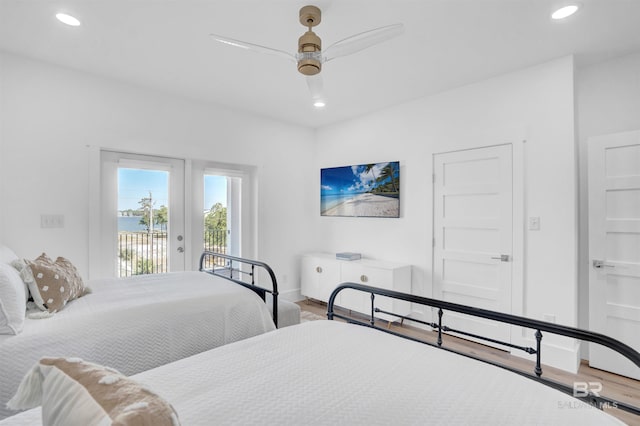 bedroom with recessed lighting, wood finished floors, and access to outside