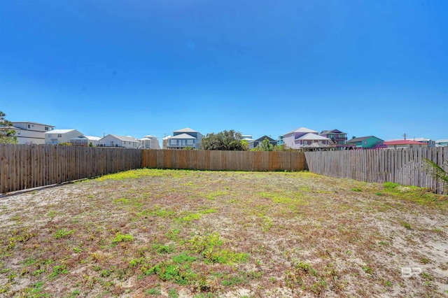 view of yard with a residential view and a fenced backyard