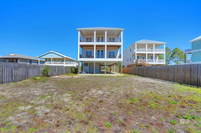 rear view of property with a fenced backyard