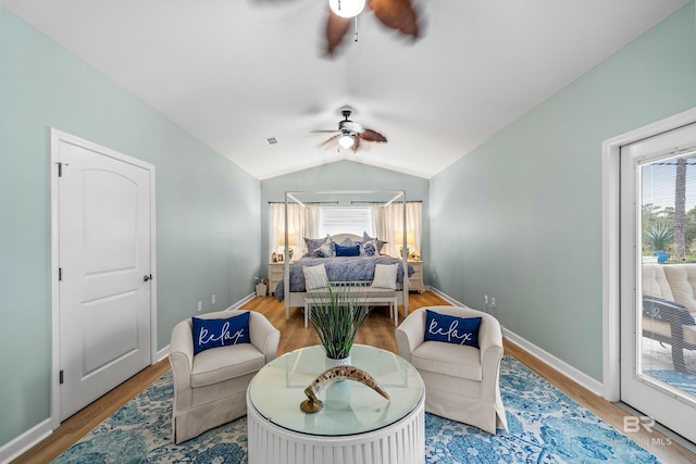 bedroom with lofted ceiling, ceiling fan, wood finished floors, and baseboards