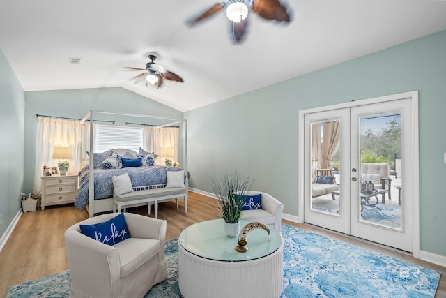 bedroom featuring lofted ceiling, wood finished floors, a ceiling fan, visible vents, and access to exterior