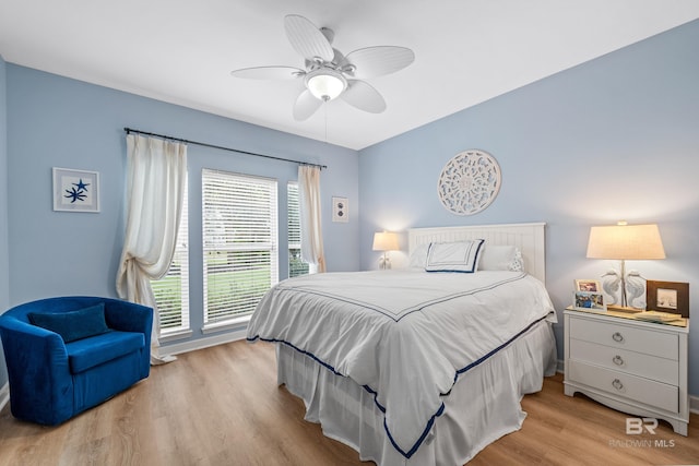 bedroom featuring light wood-style floors, access to exterior, and a ceiling fan