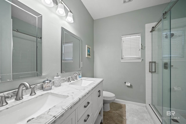 full bathroom featuring a sink, a shower stall, and tile patterned floors