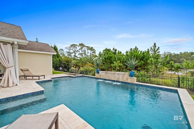 view of swimming pool featuring a patio area, fence, and a fenced in pool