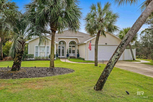 view of front of home featuring french doors, stucco siding, concrete driveway, an attached garage, and a front yard