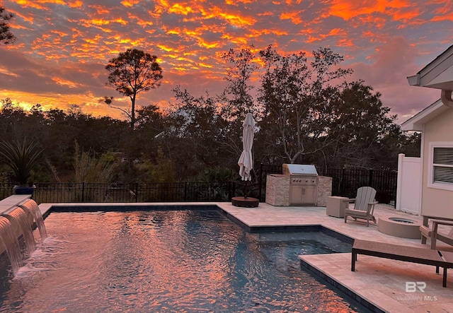 view of swimming pool featuring an outdoor fire pit, an outdoor kitchen, a fenced in pool, a patio, and fence