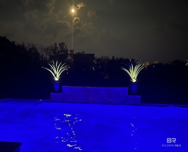 view of pool at night