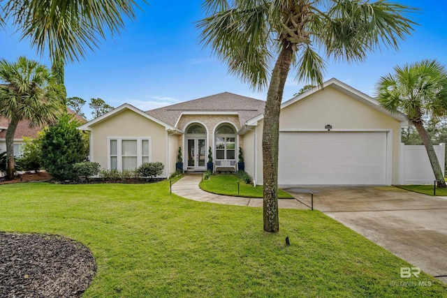 view of front of home featuring a garage, driveway, french doors, a front lawn, and stucco siding