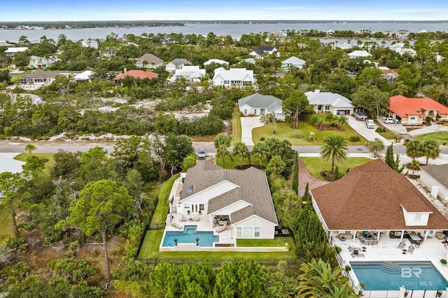 drone / aerial view with a residential view and a water view