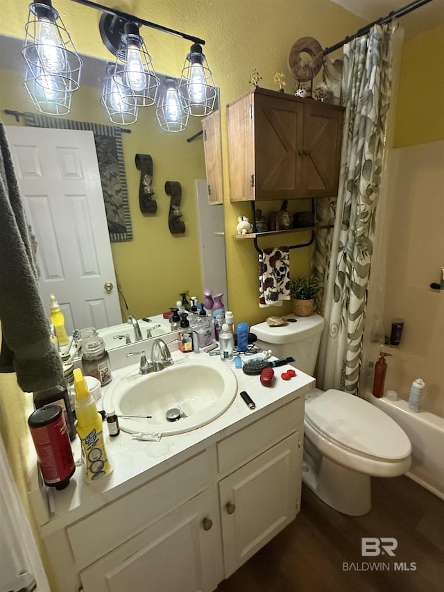 full bath with a textured wall, vanity, toilet, and shower / bathtub combination with curtain