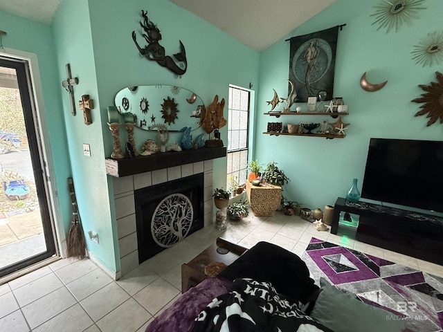 tiled living area with lofted ceiling and a fireplace