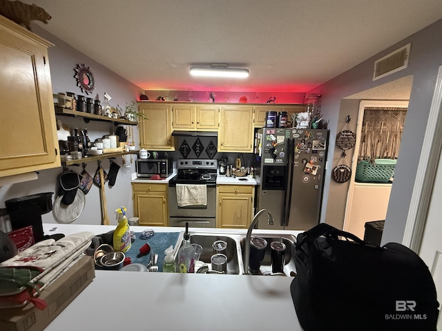 kitchen with stainless steel appliances, light countertops, visible vents, and tasteful backsplash