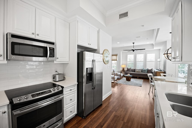 4672 Grander Ct Unit 15B, Orange Beach, AL 36561 - kitchen featuring stainless steel appliances, white cabinetry, dark wood-style flooring, ceiling fan, and open floor plan