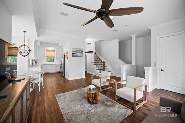 4672 Grander Ct Unit 15B, Orange Beach, AL 36561 - living area featuring a chandelier, crown molding, dark wood finished floors, stairs, and a ceiling fan