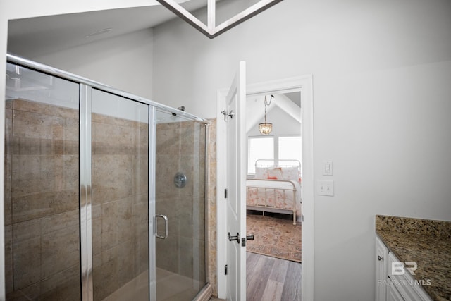 4672 Grander Ct Unit 15B, Orange Beach, AL 36561 - full bathroom featuring wood finished floors, a shower stall, connected bathroom, and lofted ceiling
