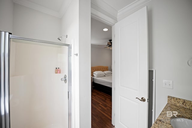 4672 Grander Ct Unit 15B, Orange Beach, AL 36561 - ensuite bathroom with crown molding, a shower stall, a ceiling fan, wood finished floors, and a sink