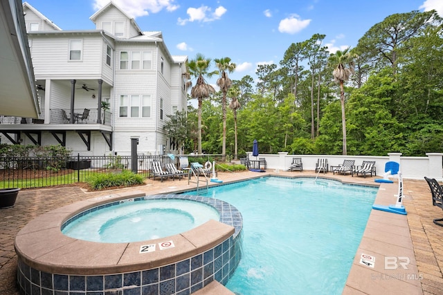4672 Grander Ct Unit 15B, Orange Beach, AL 36561 - view of pool with a pool with connected hot tub, fence, a patio area, and view of wooded area