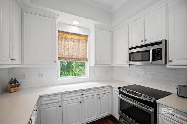 4672 Grander Ct Unit 15B, Orange Beach, AL 36561 - kitchen with stainless steel appliances, white cabinetry, backsplash, crown molding, and recessed lighting