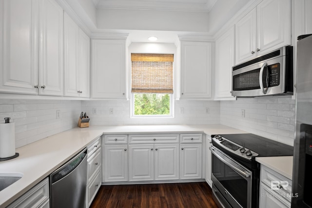 4672 Grander Ct Unit 15B, Orange Beach, AL 36561 - kitchen with stainless steel appliances, white cabinets, backsplash, dark wood-type flooring, and ornamental molding