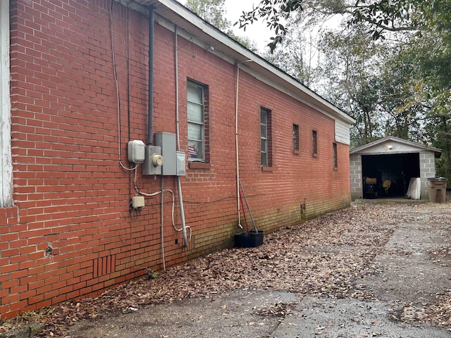 view of home's exterior with a garage and an outdoor structure