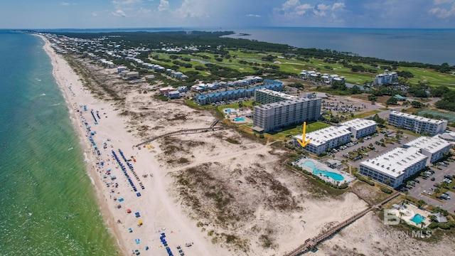 birds eye view of property featuring a beach view and a water view