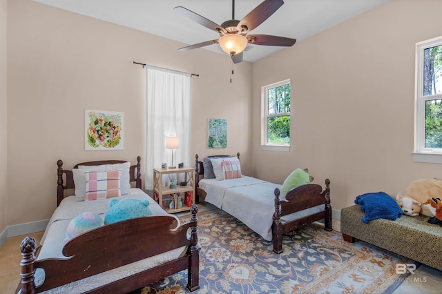 bedroom featuring multiple windows and ceiling fan