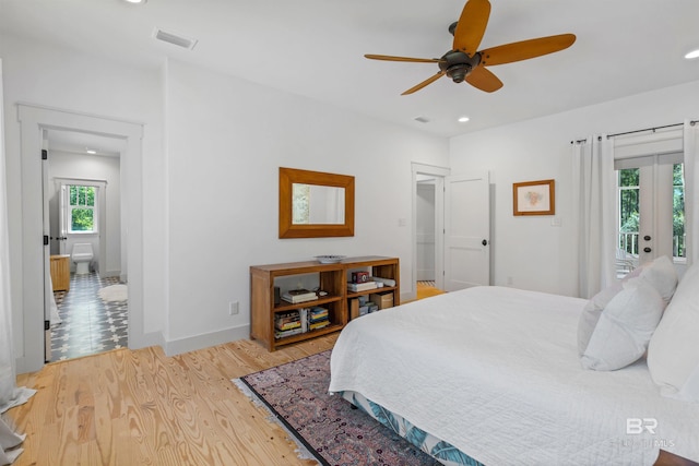 tiled bedroom featuring french doors, multiple windows, access to outside, and ceiling fan