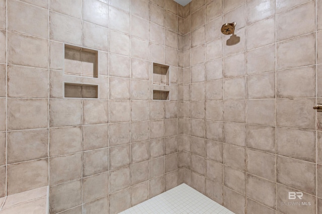 bathroom with a tile shower