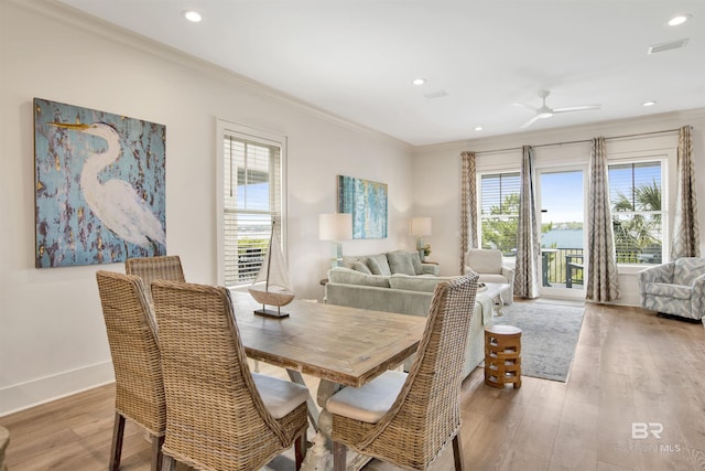 dining area with light wood finished floors, crown molding, ceiling fan, recessed lighting, and baseboards