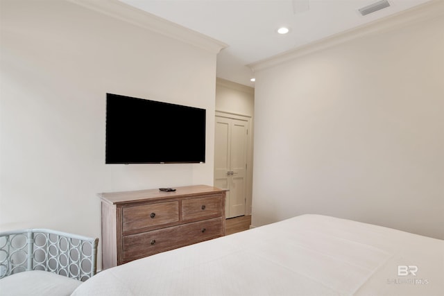 bedroom with crown molding, recessed lighting, and wood finished floors