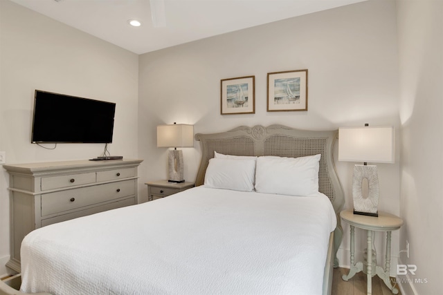 bedroom featuring baseboards, recessed lighting, and wood finished floors